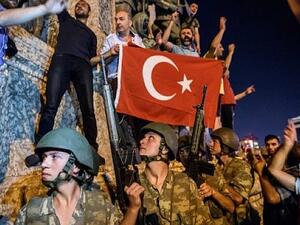 Turkish soldiers stand in Taksim Square in Istanbul as people protest against the military coup on July 16, 2016. (AFP Photo/Ozan Kose)