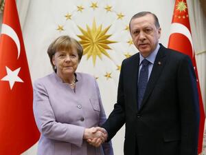 Turkish President Recep Tayyip Erdogan shakes hands with German Chancellor Angela Merkel in Ankara. (AFP Photo/KAYHAN OZER)