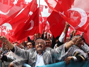 Supporters cheer Turkey's President Recep Tayyip Erdogan as he addresses an election rally in Golbasi. (AFP Photo)