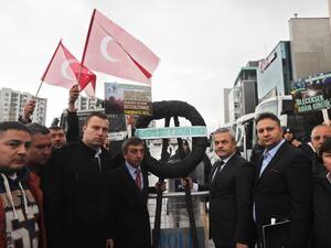 Members of the Turkish association for International Peace and Friendship (Ubdder) and ruling Justice and Development (AKP) party, gather after putting a black wreath at a blockade of anti-riot police vehicles by the Dutch embassy after the area was sealed off for "security reasons." (AFP/Adem Altan)
