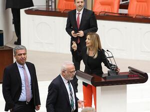 Turkish deputy Aylin Nazliaka (C) speaks with other deputies after handcuffing herself to the podium in a protest against the constitutional reform aimed at strengthening the powers of the Turkish president during a debate at the Turkish Parliament in Ankara on January 19, 2017. (AFP/Adem Altan)