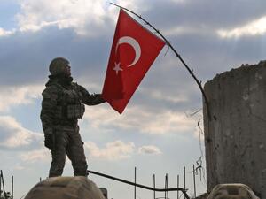 A Turkish soldier checks the national flag on a mountain on the Syrian-Turkish border, north of Azaz on Jan. 28, 2018. (AFP/ File)