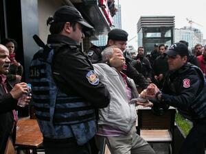 Turkish riot police arrest a protester seeking to defy a ban and march to Istanbul's Taksim square to celebrate May Day in Istanbul on May 1, 2017. (AFP/Gurcan Ozturk)