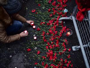 People lay flowers in front of the Reina club on January 1, 2017 in Istanbul, after a gunman killed 39 people, including many foreigners, in a rampage at a nightclub in Istanbul where revellers were celebrating the New Year. (AFP/Yasin Akgul)