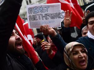 Protesters shout slogans and wave Turkish national flags in front of the Dutch Consulate on March 12, 2017 in Istanbul. Protestors briefly took down the Dutch flag at the Dutch consulate in Istanbul and replaced it with a Turkish one, AFP journalists saw, as tensions escalated in a diplomatic row. (AFP/Yasin Akgul)
