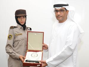 CEO of Himaya Security Colonel Ahmed Mohamed Al Hantoubi with a graduate of the first batch of female security guards at the National Security Institute in Abu Dhabi. (UAE Ministry of Interior)