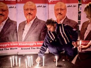 Man lights candles for Jamal Khashoggi outside the Saudi Arabia consulate in Istanbul (AFP/File)
