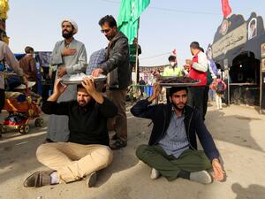Volunteers offer food to fellow pilgrims as thousands of Iranian Shiite Muslims prepare to cross the Mehran border point between Iran and Iraq, heading toward the central Iraqi shrine city of Karbala, on October 28, 2018. (ATTA KENARE / AFP)