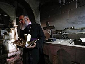 David Dosha, the priest of the Church of Mart Shmony, located in the Christian Iraqi town of Bartalla, about 15 kilometers (10 miles) east of Mosul. (AFP)