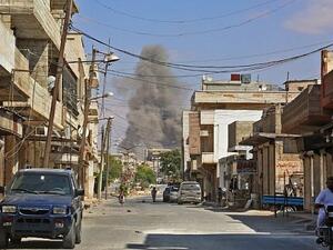 smoke rising as government forces target the city, 4 kilometers east of Khan Shaykhun in the southern countryside of Idlib province. (AFP/ File)