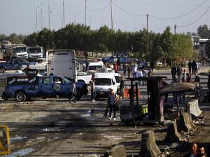 Iraqi emergency responders inspect debris at the site of a truck bomb that exploded at a crowded checkpoint in the Iraqi city of Hilla, south of Baghdad. (AFP/ File)