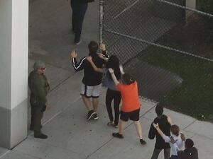 People are brought out of the Marjory Stoneman Douglas High School after a shooting at the school that reportedly killed and injured multiple people on February 14, 2018 in Parkland, Florida. (AFP/ File Photo)