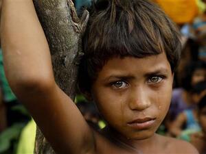 A Rohingya refugee girl is seen crying in front of newly-arrived refugees who fled to Bangladesh from Myanmar in Ukhiya. (AFP/ File Photo)