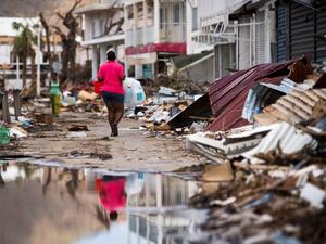 A woman walks on a street in Marigot, on September 11, 2017 on the French Caribbean island of Saint-Martin after it was hit by Hurricane Irma. (Martin Bureau/AFP)