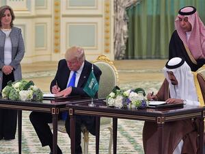 US President Donald Trump and Saudi Arabia's King Salman signing the deal (AFP/Mandel Ngan)