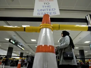 A passenger from a Riyadh, Saudi Arabia inbound flight, arrives at the international arrivals hall at Washington Dulles International Airport February 6, 2017. (AFP/Brendan Smialowski)
