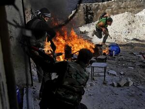 Syrian rebels of the Halab al-Shabah battalion under Al-Tawhid brigade take position during clashes with regime forces in Al-Amariya district of the northern city of Aleppo. (AFP/File)

