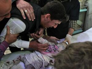 A Syrian cries over body of a lifeless baby on November 2, 2017 in the Eastern Ghouta region outside Damascus. (AFP/ File Photo)