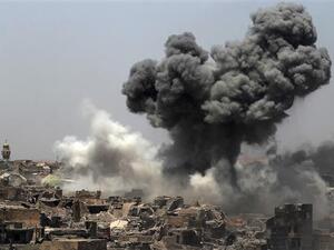 A picture taken on July 9, 2017, shows smoke billowing following an airstrike by US-led international coalition forces in Mosul, Iraq. (AFP)