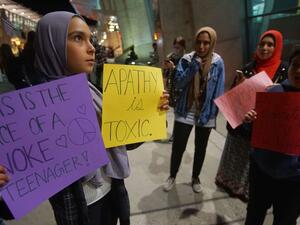 A group of Muslim protesters gather during a rally against the travel ban at San Diego International Airport. (AFP)