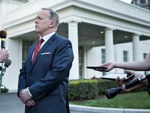 White House Press Secretary Sean Spicer speaks to a reporter about a comparison he made between Syria's President Bashar al-Assad and Hitler during an earlier press briefing at the White House April 11, 2017 in Washington, DC. (AFP/Brendan Smialowski)