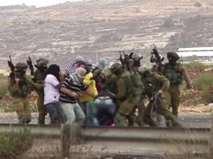 Video footage shows undercover Israeli forces beating a Palestinian youth. (AFP)