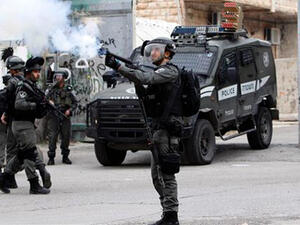An Israeli soldier fires tear gas towards Palestinian protesters during clashes in the occupied West Bank city of Bethlehem on March 22, 2017. (AFP)