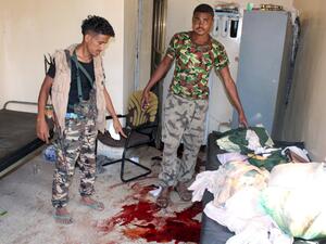 Loyalist forces to embattled President Hadi examine the aftermath of the attack on an elderly care home in Aden. (AFP/Saleh Al-Obeidi)