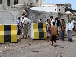 People gather at the site of a car bombing near the Foreign Ministry in Aden on Friday. (AFP/Saleh Al-Obeidi)