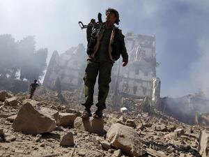 Houthi rebel fighters inspect the damage after a reported airstrike carried out by the Saudi-led coalition targeted the presidential palace in the Yemeni capital Sana'a. (AFP/ File)