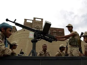 Armed Houthi rebels ride in the back of a truck during a rally in the capital Sanaa. (AFP/Mohammed Huwais)