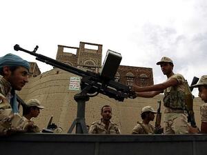 Armed Houthi rebels ride in the back of a truck during a rally in the capital Sanaa. (AFP/Mohammed Huwais)