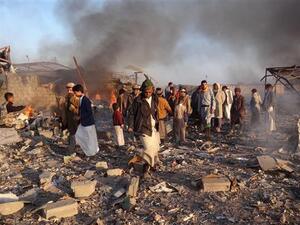 Smoke rises as Yemenis inspect the damage at the site of Saudi-led airstrikes in the northwestern city of Sa’ada, Yemen