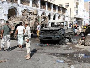 People gather at the site of a car bomb explosion next to the central bank in Yemen's second city of Aden. (AFP/ File)