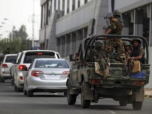 Security forces ride on the back of a patrol truck escorting UN special envoy to Yemen Ismail Ould Cheikh Ahmed upon his arrival at Sanaa airport on May 22, 2017. (AFP/Mohammed Huwais)