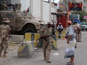 Loyalist forces stand guard outside the central prison in the Mansoura residential district of Yemen's Aden after pushing Al-Qaeda out of parts of the southern city on March 30, 2016. (Saleh al-Obeidi)