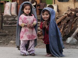 Afghan children watch a platoon of American soldiers, 24 September 2012. (AFP/Tony Karumba)