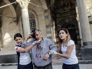 Medical aid workers help a man wounded by Daesh rocket fire in Kilis, Turkey. (AFP/Yasin Akgul)