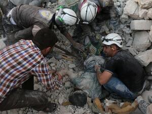Syrian civil defence volunteers remove the body of a man from the rubble of destroyed buildings following reported airstrikes on April 27, 2016 in the rebel-held eastern neighbourhood of Bab al-Nayrab in the city of Aleppo. (AFP/Ameer al-Halbi)