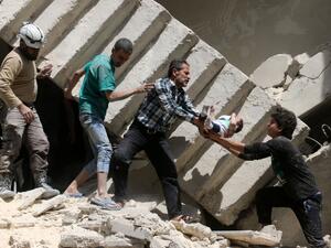 Residents of Aleppo's al-Kalasa district rescue a toddler after an air raid destroyed his home on April 28, 2016. (AFP/Ameer Alhalbi)   