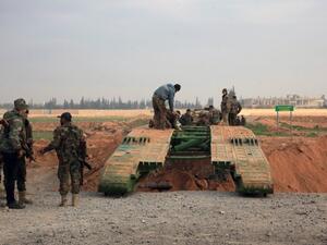 Members of the government forces install a retractable military bridge to cross a trench on the eastern outskirts of the Syria's northern embattled city of Aleppo after they re-took the area from Daesh fighters on February 21, 2016. (AFP/George Ourfalian)