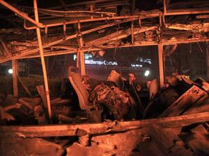 A man looks into a burnt-out bus at the site of a blast in Ankara on March 13, 2016. (AFP/Mehmet Ozer)
