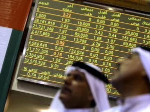 Emirati traders follow the stock market activity at the Dubai Financial Market. (Karim Sahib/ AFP)