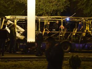 Armenian police investigators work at the site of a bus explosion in Yerevan on April 25, 2016, which killed at least one passenger and wounded six in the Armenian capital Yerevan. (AFP/Karen Minasyan)
