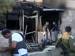 Security forces inspect the West Bank house destroyed in an arson attack on July 31, 2015. (AFP/Jaafar Ashtiyeh)