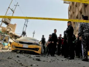 Iraqis gather at the site of a car bombing near Baghdad's Al-Shuhada Bridge on May 30, 2017. (AFP)