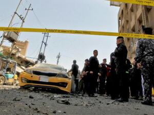 Iraqis gather at the site of a car bombing near Baghdad's Al-Shuhada Bridge on May 30, 2017. (AFP)