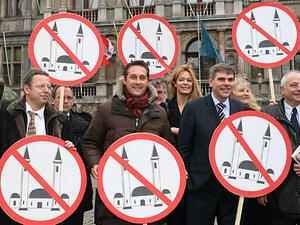 Members of several European right-wing parties pose with signs, after the presentation of their organization of "Cities against Islamization" in Antwerp. (AFP/Jorge Dirkx)