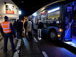 Passengers on the way from France to Belgium stand outside during a police border control in Adinkerke on February 23, 2016 as Belgium announced it would reinstate border controls fearing an influx of migrants. (AFP/David Stockman)