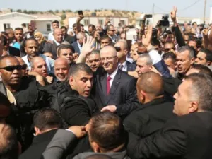 Palestinian Authority Prime Minister Rami Hamdallah is surrounded by security (AFP/File Photo)	